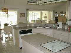 Kitchen with breakfast bar and chefs island, with view of the golf course.Pleasant views while working the kitchen make time go by quickly.