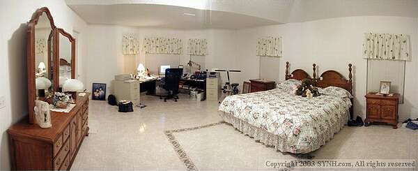 Master Bedroom, this room was expanded and serves as an office area at the Bay window, facing (east) to view the golf course. A doorway provides direct access to the Lanai.